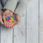 closeup-two-young-lovers-holding-hands-table